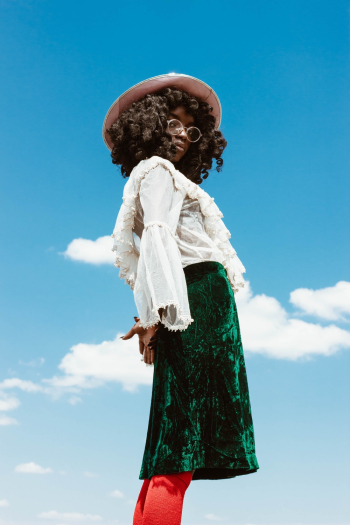 Woman in White Long-sleeved Top and Green Skirt Standing Outdoors Woman in White Long-sleeved Top and Green Skirt Standing Outdoors