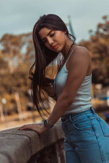 Woman In White Tank Top And Blue Denim Bottoms Woman In White Tank Top And Blue Denim Bottoms