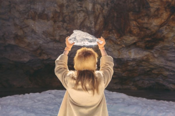 Woman In Winter Fashion Holding Ice Above Woman In Winter Fashion Holding Ice Above