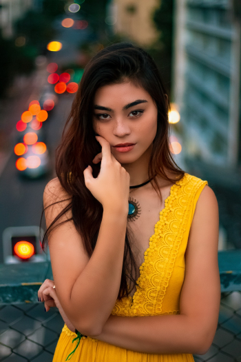 Woman in Yellow V-neck Sleeveless Dress Leaning on Fence Woman in Yellow V-neck Sleeveless Dress Leaning on Fence
