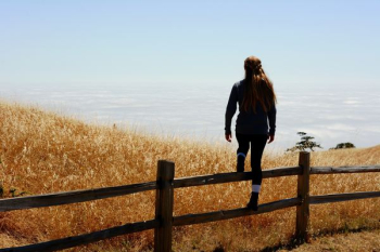 woman jump on brown fence woman jump on brown fence
