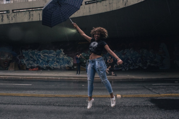 Woman Jumping and Holding Umbrella Woman Jumping and Holding Umbrella