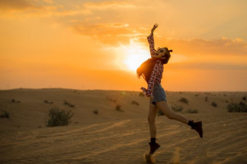 woman jumping on desert during golden hour woman jumping on desert during golden hour
