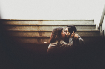 Woman Kissing Another Woman On Cheek Woman Kissing Another Woman On Cheek