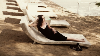 Woman Laying on Beige Lounger Woman Laying on Beige Lounger