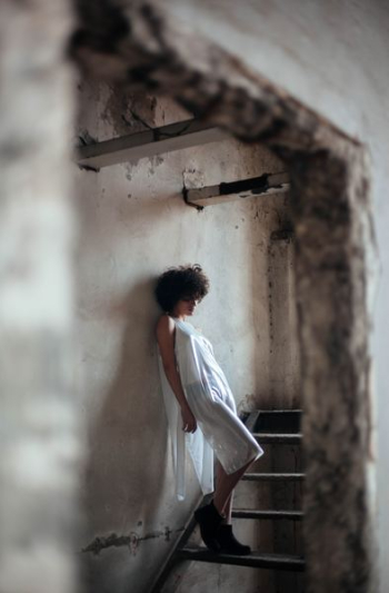 woman leaning on wall