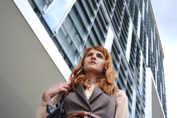 Woman Looking at Modern Office Building Woman Looking at Modern Office Building