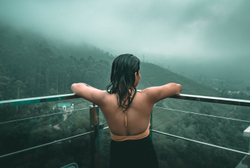 Woman Looking Out a Balcony Woman Looking Out a Balcony