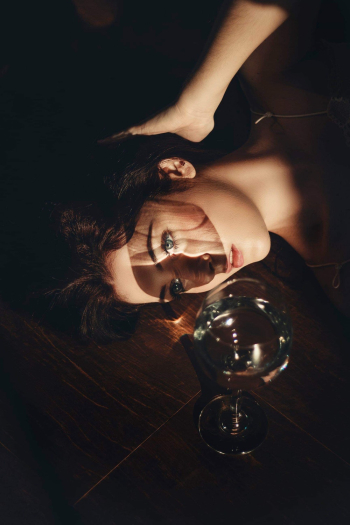Woman Lying Beside Clear Wine Glass Woman Lying Beside Clear Wine Glass