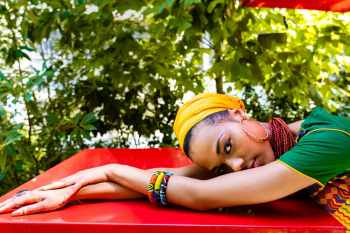 Woman Lying Her Head on Red Tabletop Woman Lying Her Head on Red Tabletop
