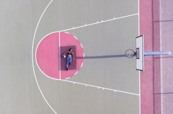 Woman Lying on Basketball Free Throw Line
