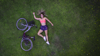 Woman Lying on Grass Field