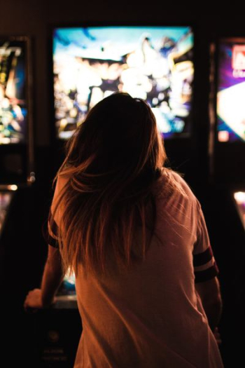 woman playing arcade woman playing arcade