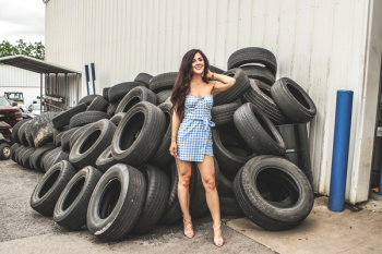 Woman posing in front of Tires Woman posing in front of Tires