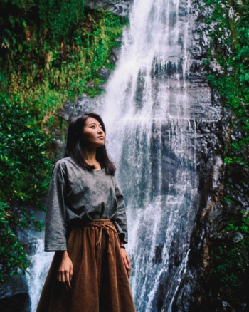 woman posing near the waterfalls