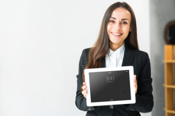 Woman presenting tablet mockup Free Psd