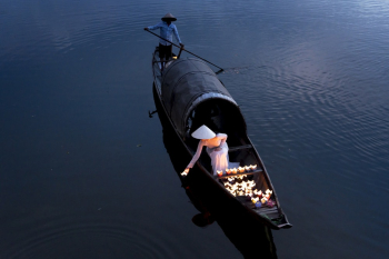 Woman Putting Candles on Water