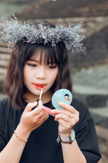 Woman Putting Lip Tint on Her Lips Woman Putting Lip Tint on Her Lips