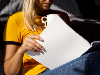 Woman reading a mock-up magazine Free Photo