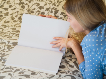 Woman reading a mock-up magazine Free Photo