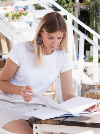 Woman reading a mock-up magazine Free Photo