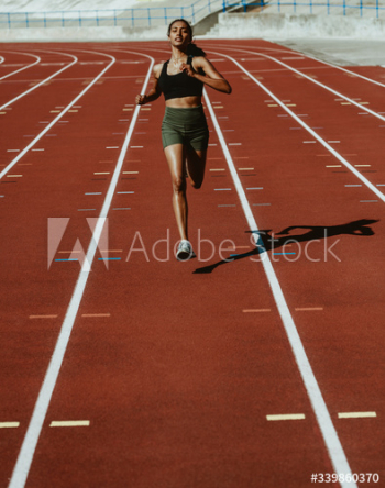 Woman runner training hard on a running track