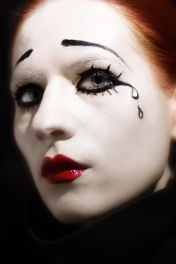 woman's face painted as sad mime woman's face painted as sad mime