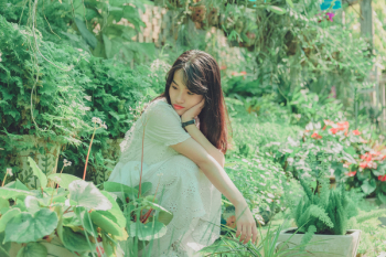 Woman Sit Squats in Garden Woman Sit Squats in Garden