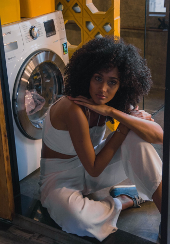 Woman Sitting Beside Front-load Clothes Dryer Woman Sitting Beside Front-load Clothes Dryer