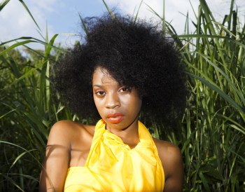 Woman Sitting Beside Grass