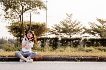 Woman Sitting Near Grass