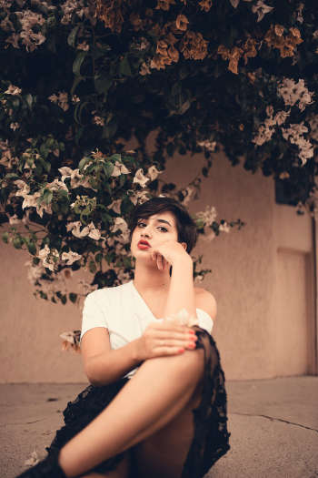 Woman Sitting Near Plant Woman Sitting Near Plant
