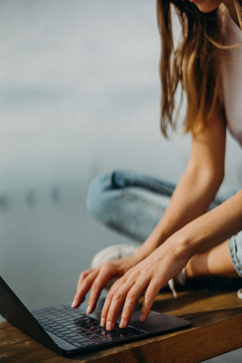 Woman Sitting on Bench Browsing Laptop Woman Sitting on Bench Browsing Laptop