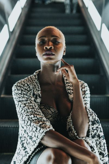 woman sitting on escalator