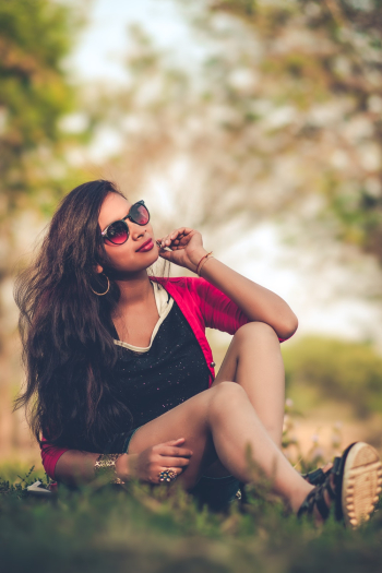 Woman Sitting On Grass