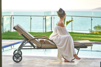 Woman Sitting On Lounge Chair Woman Sitting On Lounge Chair