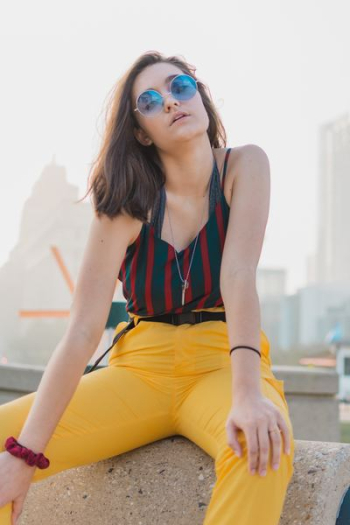 woman sitting on marble bench near wall