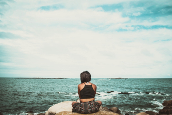 Woman Sitting On Rock Woman Sitting On Rock