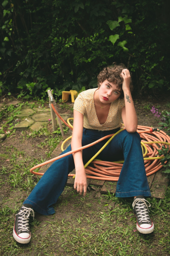 Woman Sitting on Water Hose
