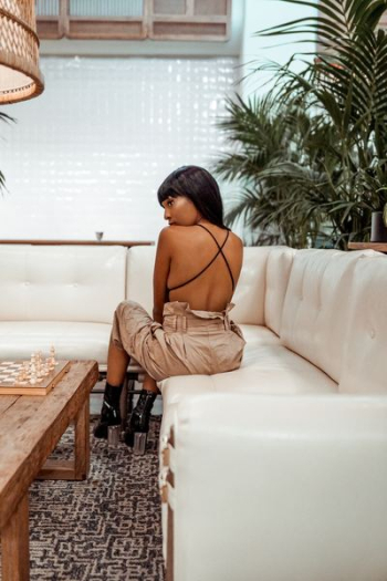 woman sitting on white leather sectional sofa woman sitting on white leather sectional sofa