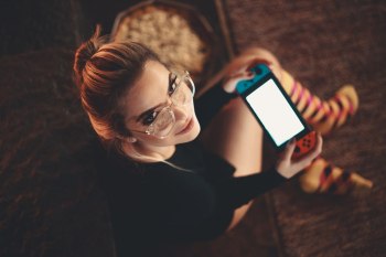 Woman Sitting Playing On Nintendo Switch Woman Sitting Playing On Nintendo Switch