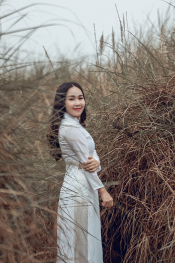 Woman Smiling Beside Bushes Woman Smiling Beside Bushes