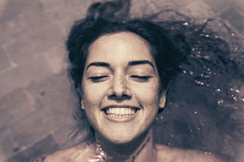 woman smiling while bathing