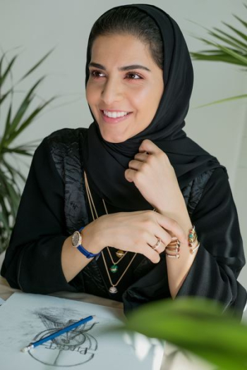 woman smiling while sitting on chair