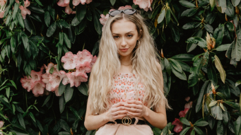 Woman Standing Against Flowers Woman Standing Against Flowers