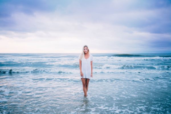 woman standing at sea woman standing at sea