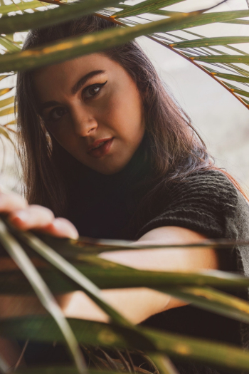 Woman Standing Behind Grass