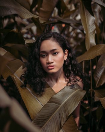 Woman Standing Behind Leaves Woman Standing Behind Leaves