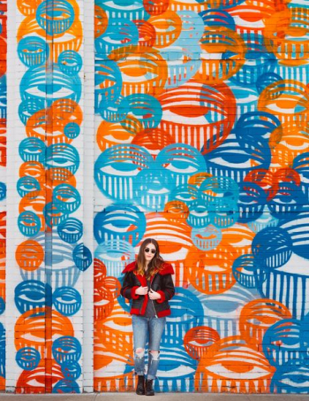 woman standing beside on wall street art woman standing beside on wall street art