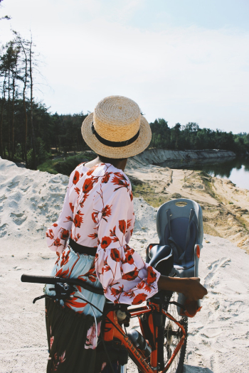 Woman Standing Beside Orange Mountain Bike Woman Standing Beside Orange Mountain Bike